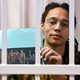Brittney Griner sits inside a defendants’ cage with a picture depicting her WNBA fellow players wearing jerseys with her number, 42, during the leagues All-Star Game, during a hearing at the Khimki Court in the town of Khimki outside Moscow on July 15, 2022. - (Photo by NATALIA KOLESNIKOVA / AFP) (Photo by NATALIA KOLESNIKOVA/AFP via Getty Images)